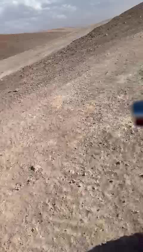 A quad bike crossing the desert trail