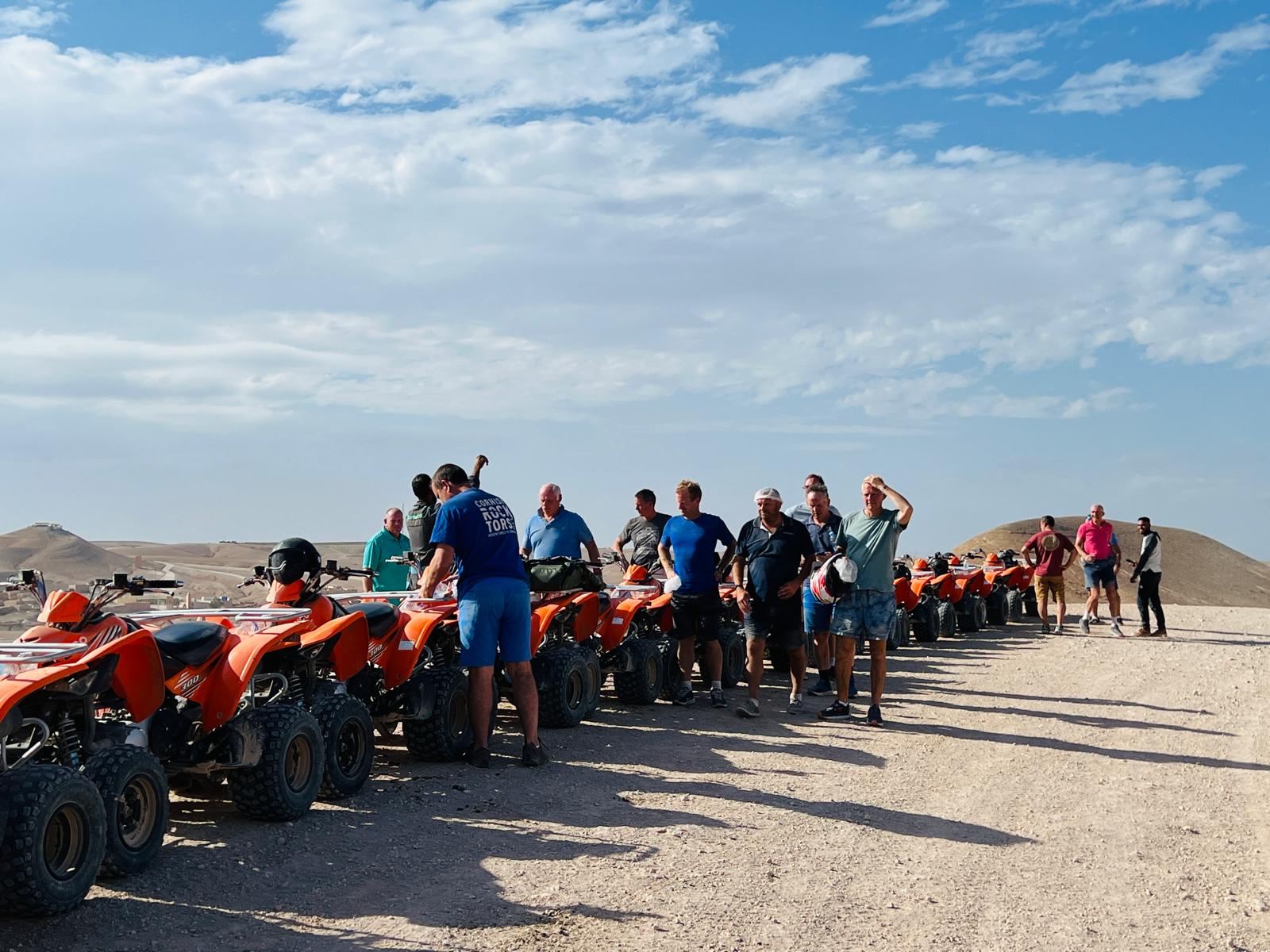 The group lined up with quad bikes in the desert