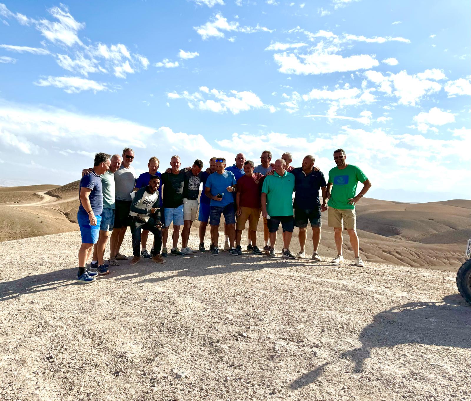 The Reloaders posing under a bright desert sky