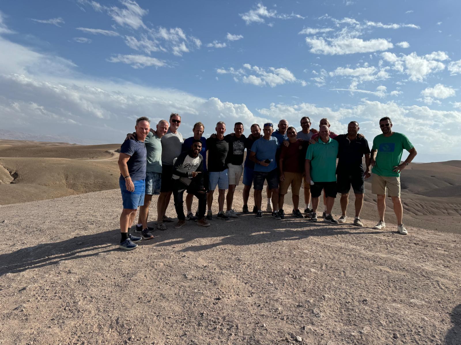 A wide group photograph in the Marrakech desert