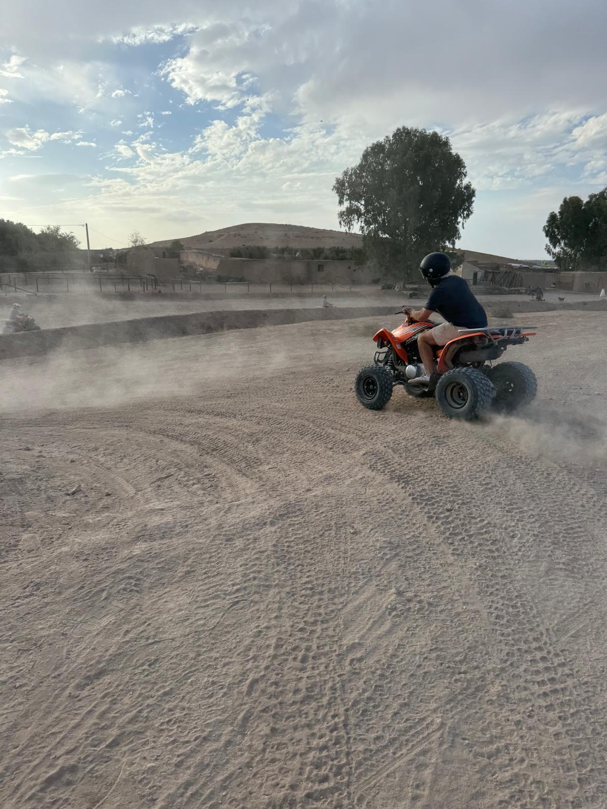 A quad-bike rider crossing the desert