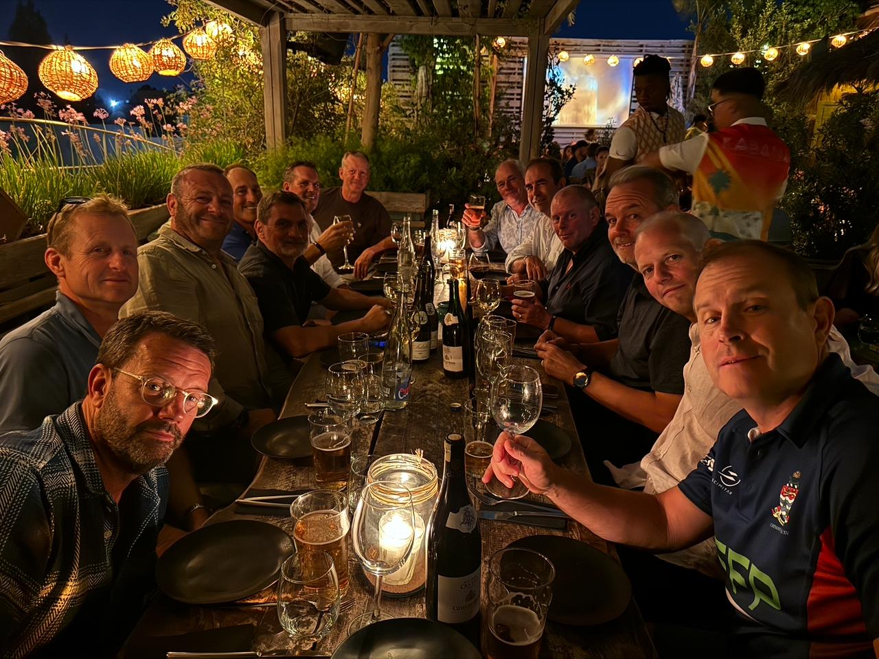 A wide group photograph at dinner