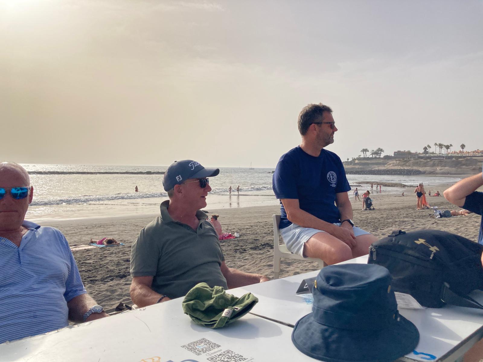 The group enjoying drinks beside the beach
